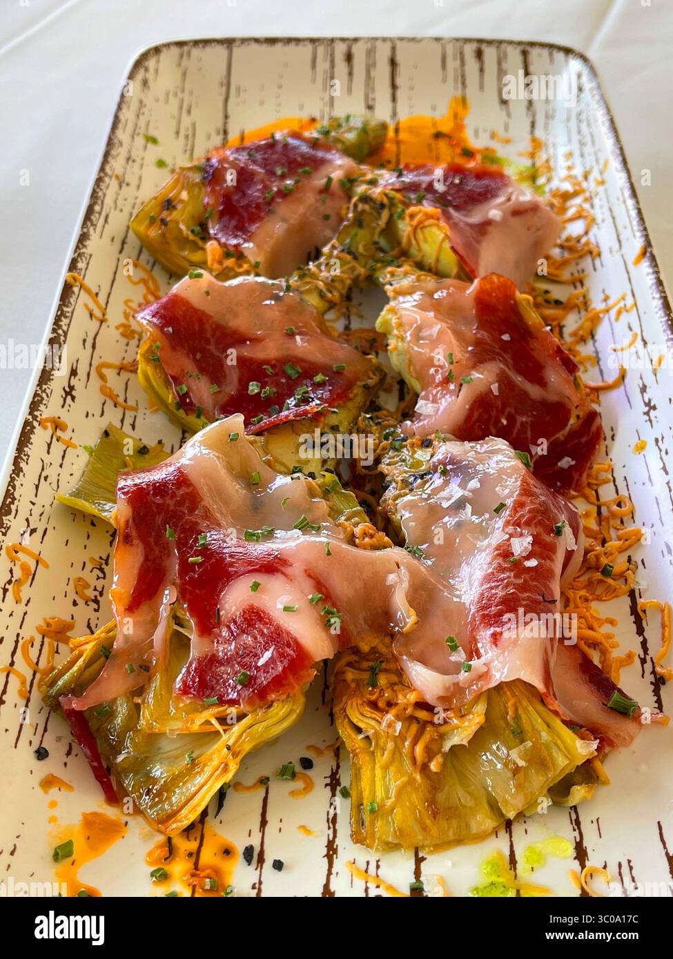 Artichokes with Iberian ham. Spain. - Smartphone Captured Stock Image
