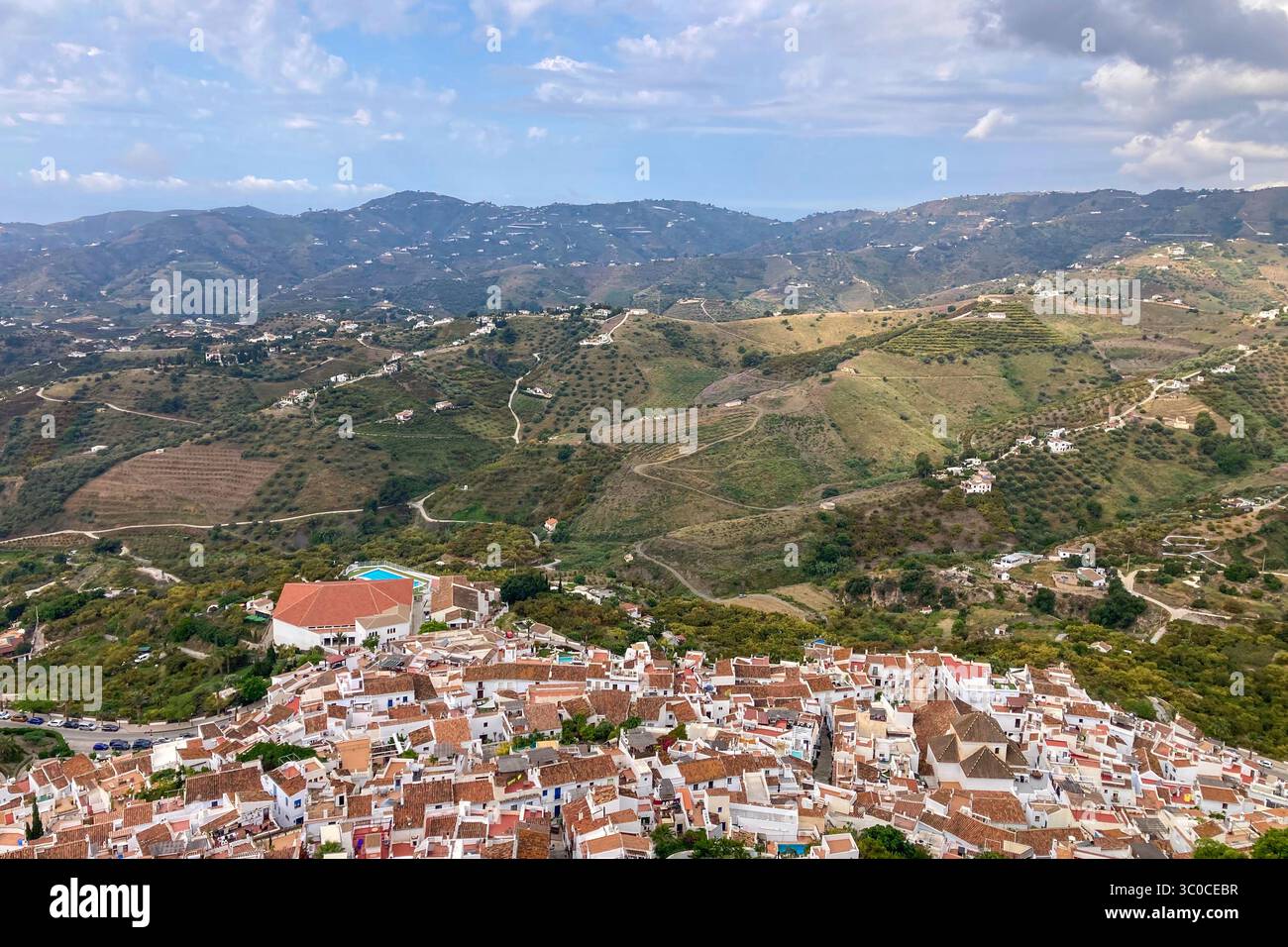 FRIGILIANA, SPAIN - MAY 10, 2025: A peaceful walk through the charming narrow streets, surrounded by whitewashed houses and colorful flowers in Frigil - Smartphone Captured Stock Image