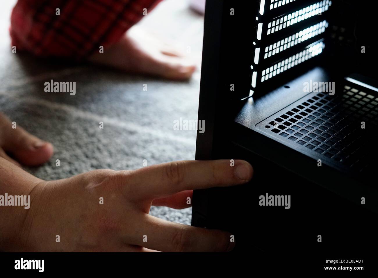 man repairing computer working home looking fixing broken engineer hardware pc service support Stock Photo