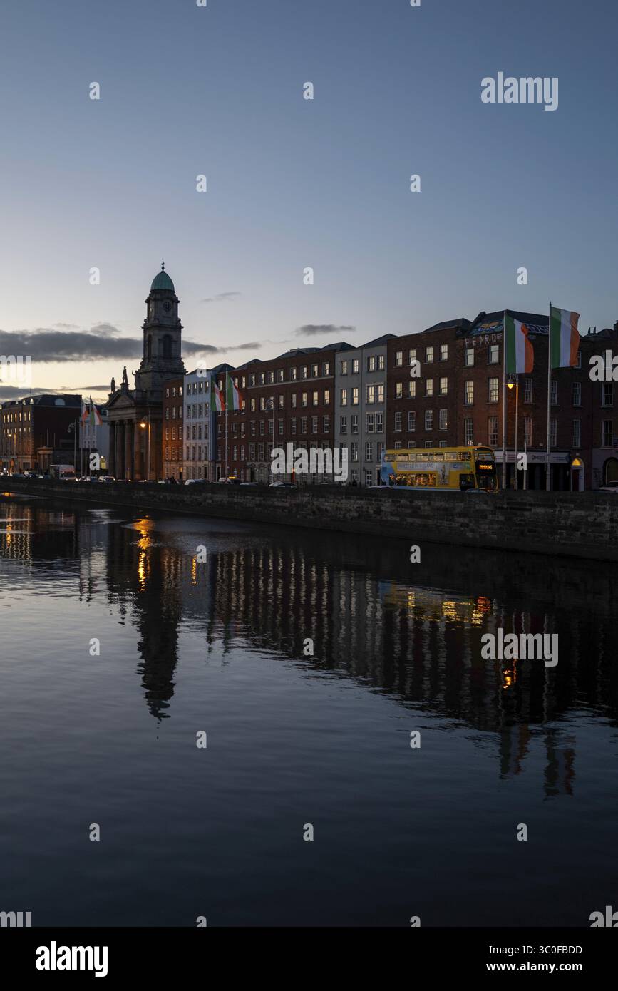 A view of a beautiful reflection of buildings along the River Liffey in ...