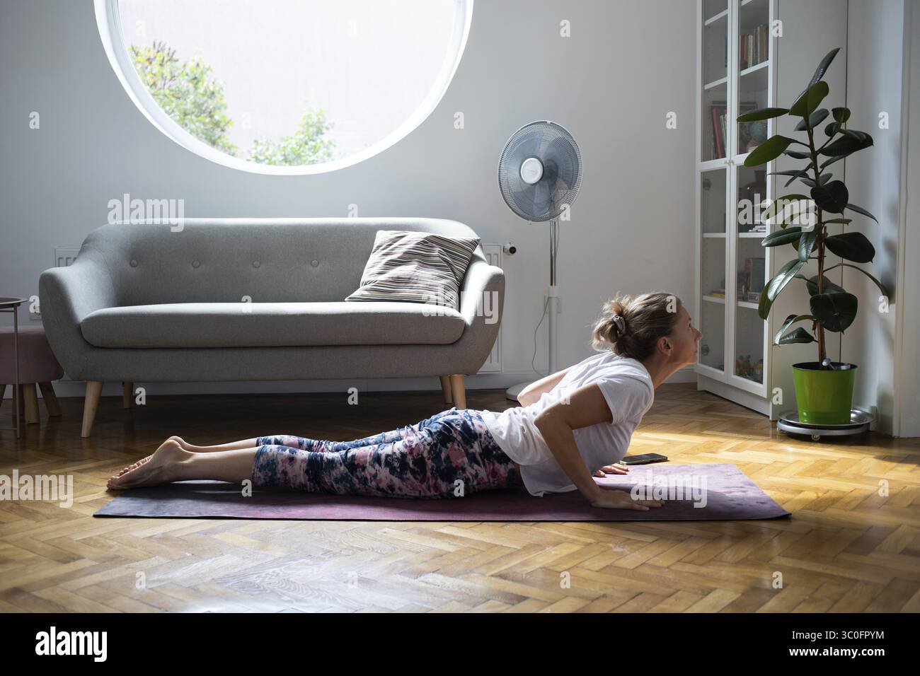 Woman doing yoga at home healthy lifestyle Stock Photo - Alamy