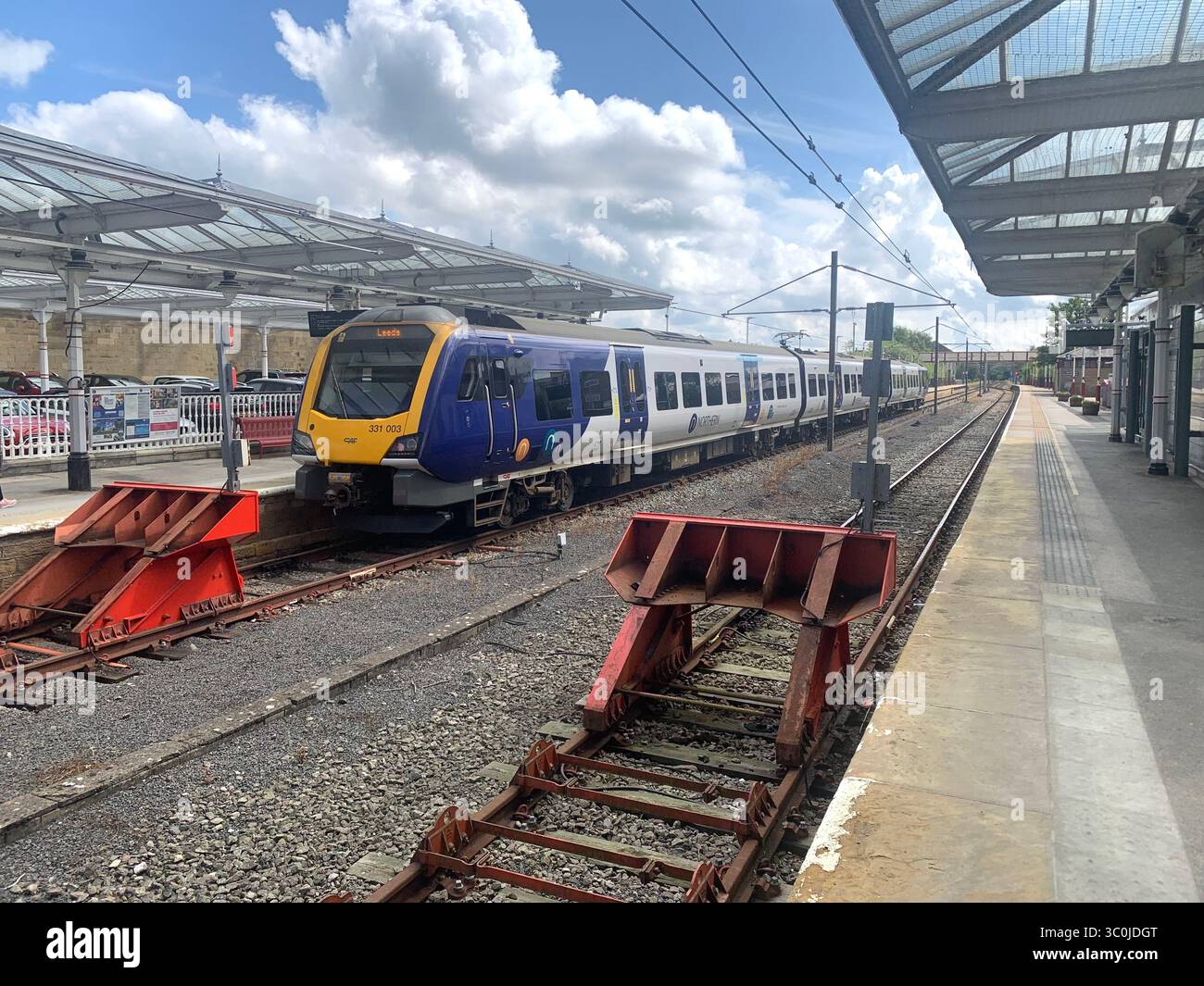 Ilkley Yorkshire railway station train track buffer platform ticket office sign signs old style type North people walking catching the train chairs UK - Smartphone Captured Stock Image