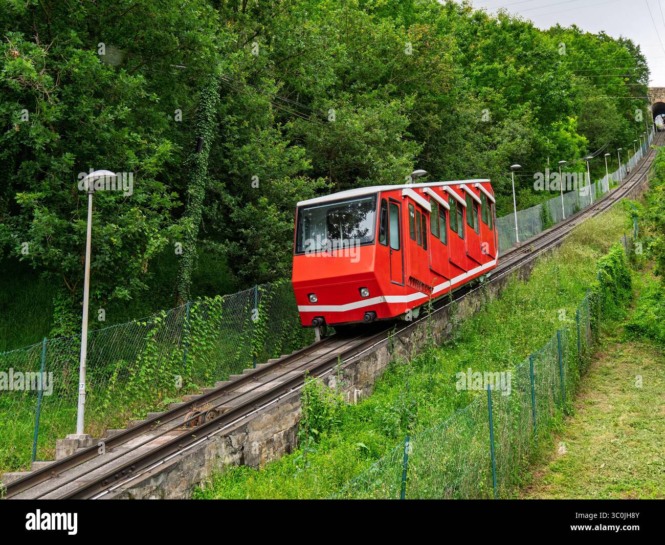 Red Funicular Train A red funicular climbs the hillside in Bilbao, offering scenic views of ...