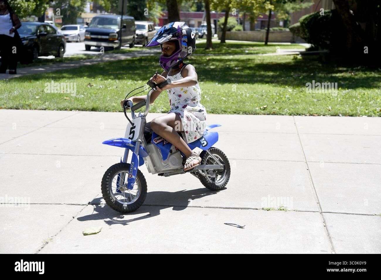 October 29, 2018 - Baltimore, MD, USA - Darah Thames rides an electric dirt bike outside the Liberty Recreation Center in August 2017. Engineer Brittany Young launched B-360, a program that helps get Baltimore kids interested in STEM fields through dirt bikes. (Credit Image: © Kim Hairston/Baltimore Sun/TNS via ZUMA Wire) Stock Photo