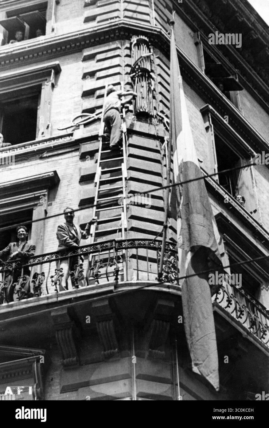 Fascist Office Rome Some men removing the fasces from the facade of a building following ...