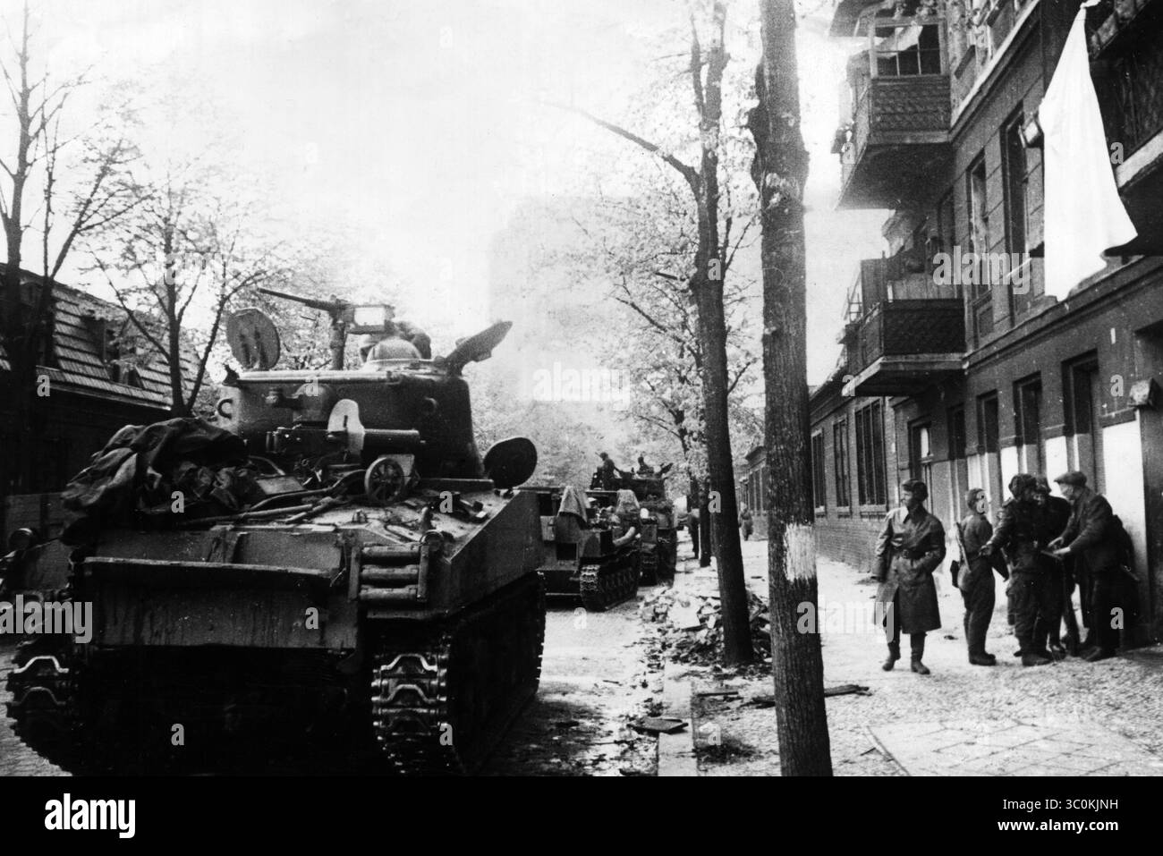 Russian tanks in the streets of Berlin where a white sheet hangs from a ...