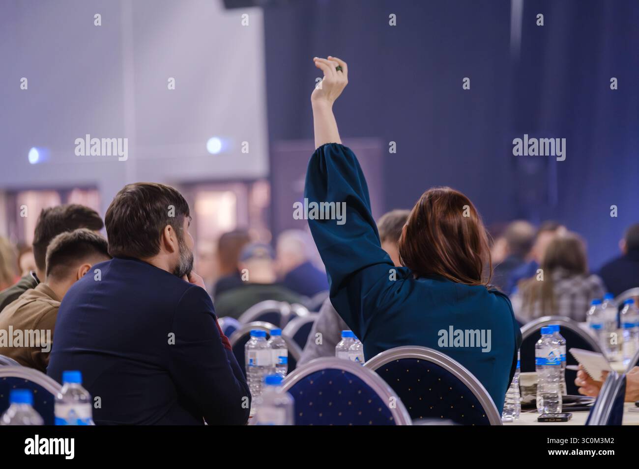 Public speaker engaging people raising hi-res stock photography and ...