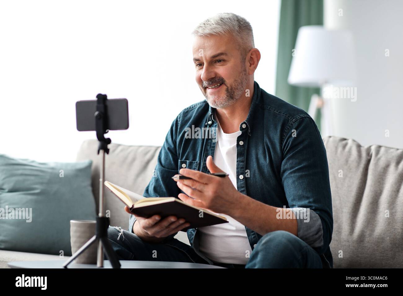 Happy elderly man studying online while staying home Stock Photo