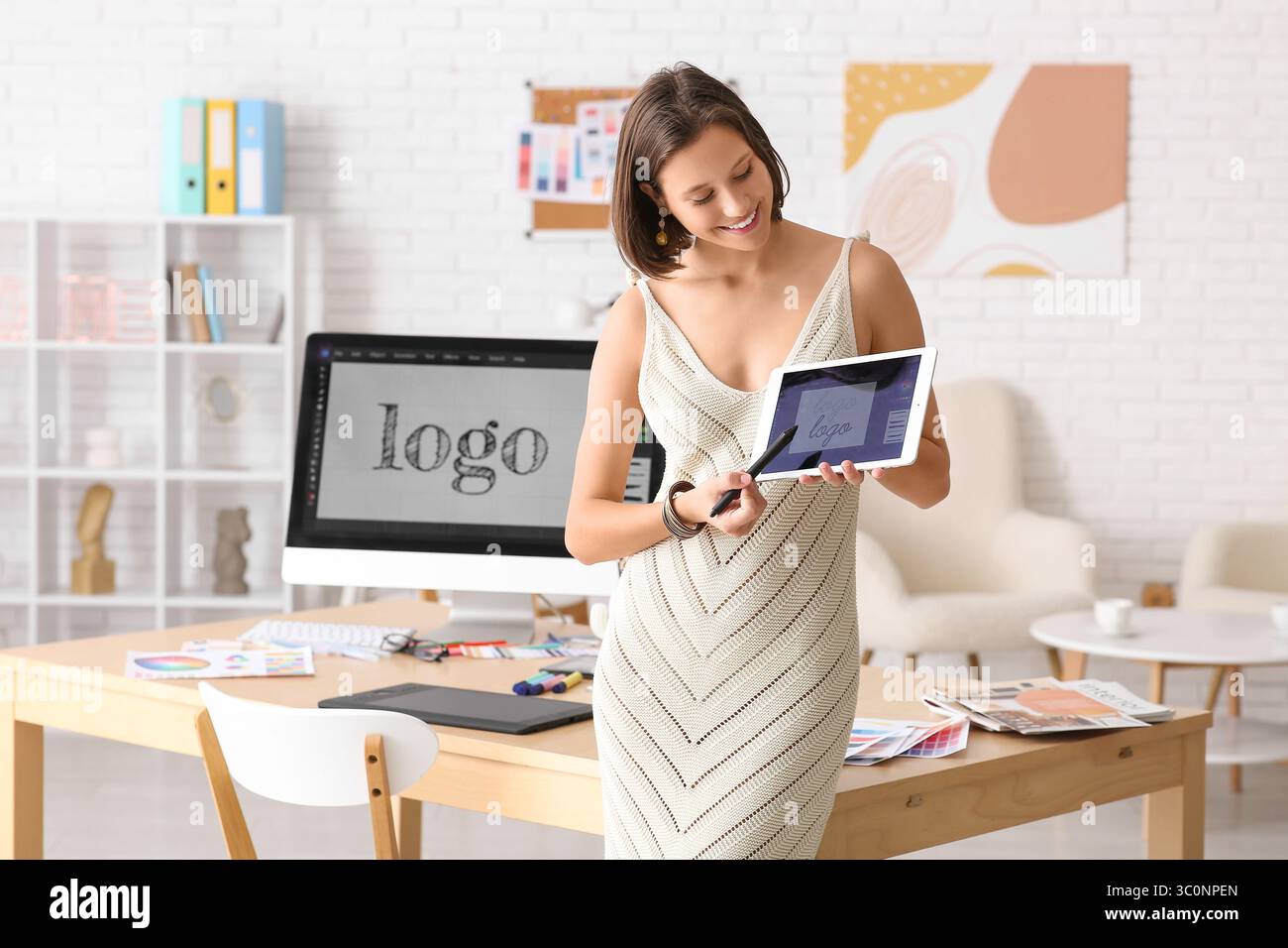 Young female graphic designer with tablet computer in office Stock ...
