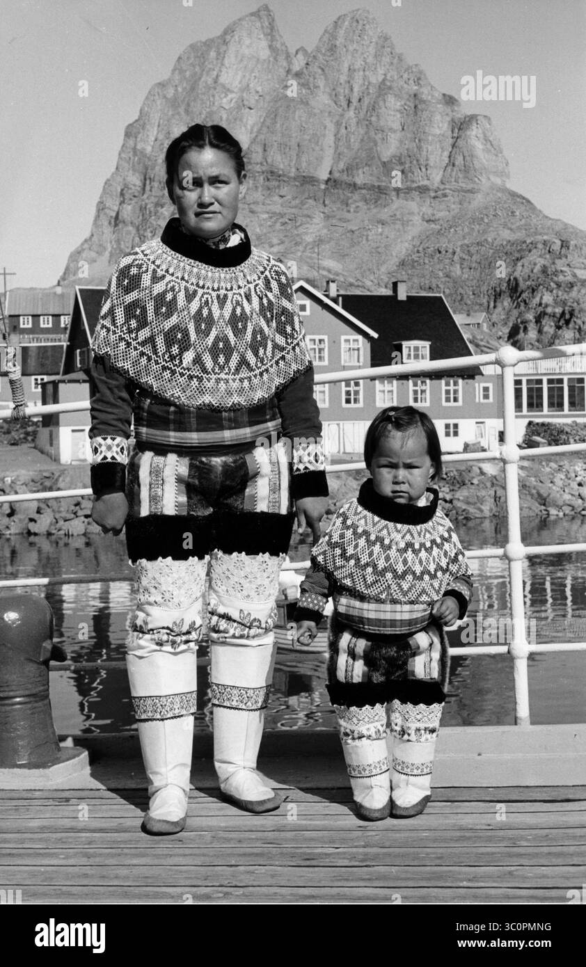An Inuit woman and a girl posing with their traditional costumes ...