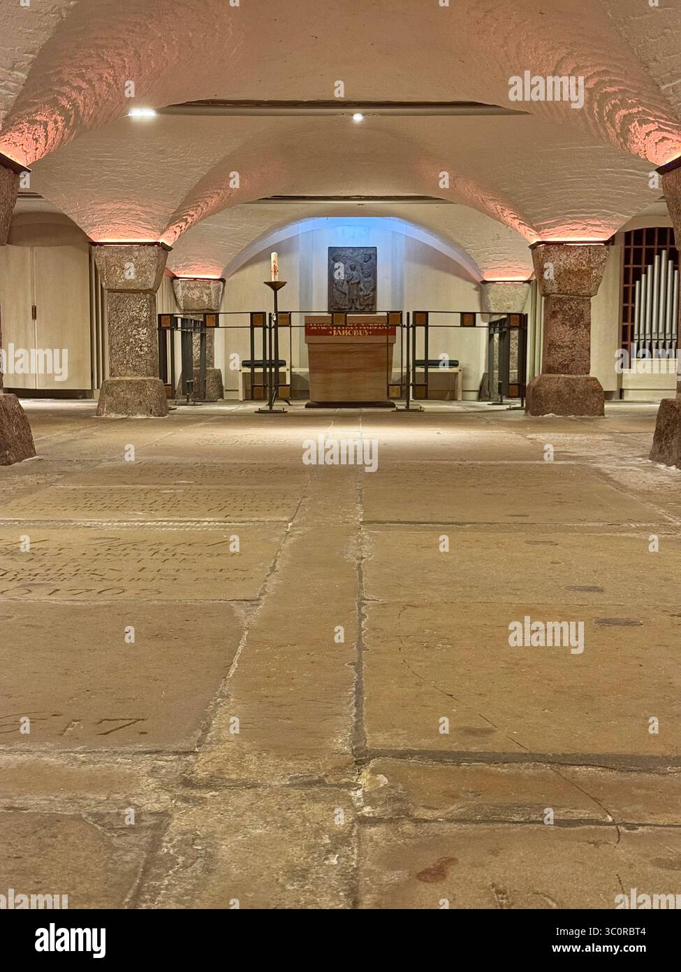 Interior of the crypt in St. Michael’s Church (Michel) in Hamburg, Germany, featuring an altar, stone floor, and vaulted ceiling. - Smartphone Captured Stock Image