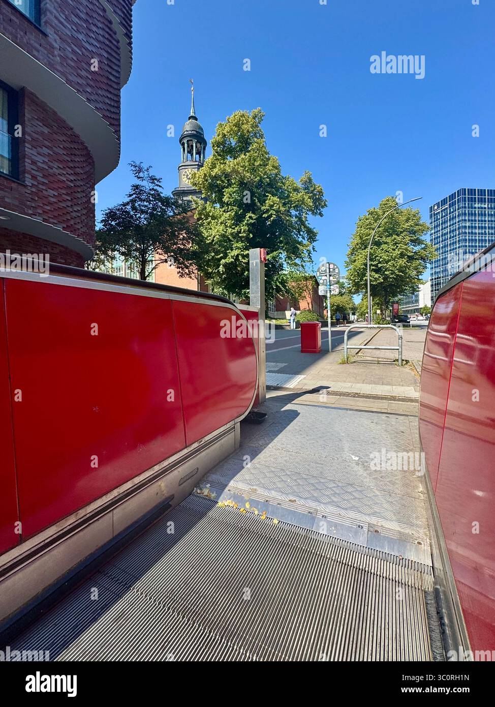 View from an escalator exit on a street in Hamburg, Germany, with St. Michael’s Church (Michel) visible in the background. - Smartphone Captured Stock Image