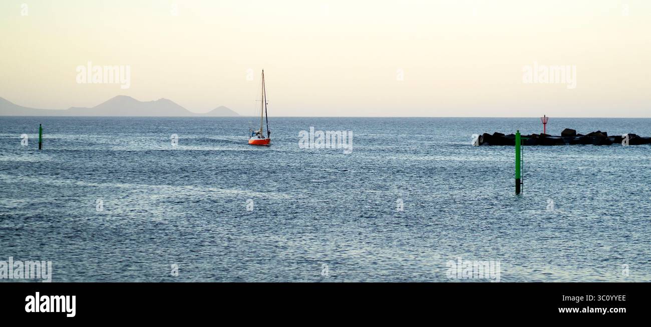 A red yacht sails across the Atlantic Ocean at sunset Stock Photo - Alamy