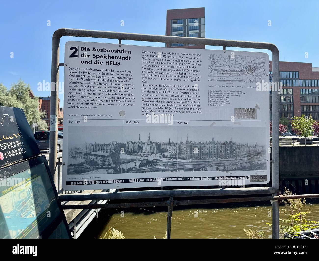 Information board detailing the expansion phases of Speicherstadt and the HFLG in Hamburg, Germany, displayed near the waterfront. - Smartphone Captured Stock Image