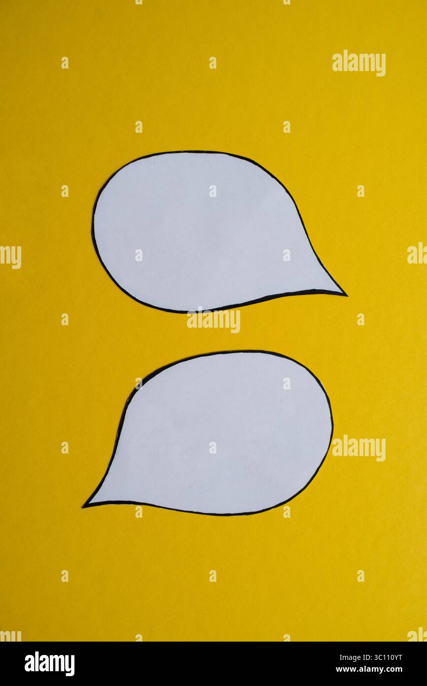 Two Blank Speech Bubbles on Yellow Background Stock Photo
