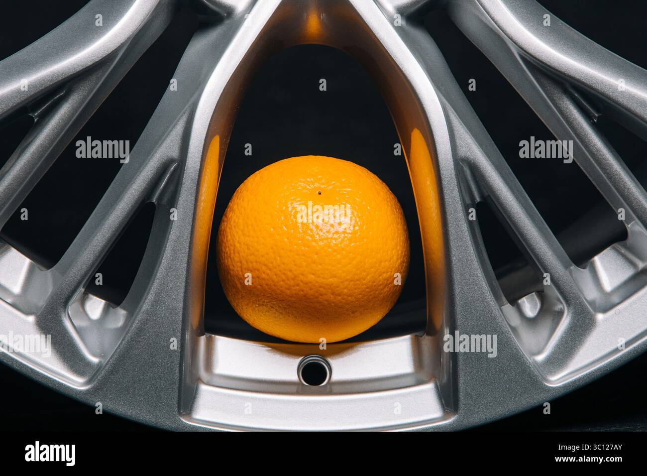 Car rims at the dark background with orange close up Stock Photo - Alamy