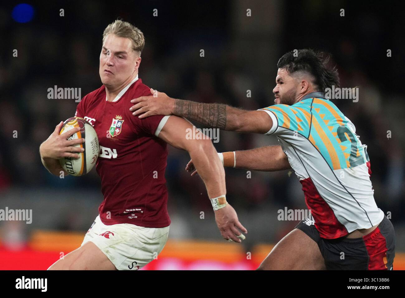 Duhan van der Merwe of the British & Irish Lions, left, is tackled by ...