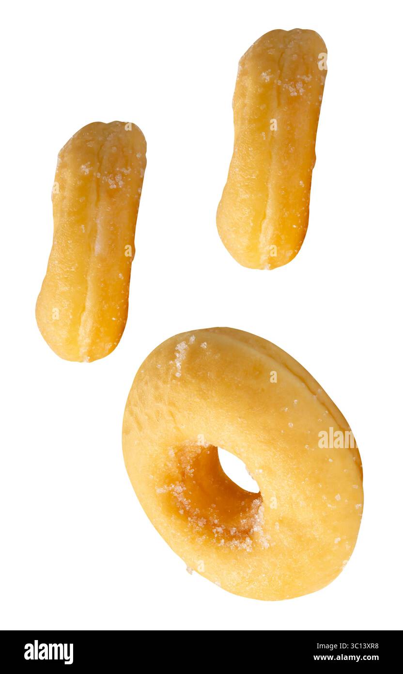 Top view set of three pieces of scattering cinnamon donuts is isolated on white background with clipping path. Stock Photo