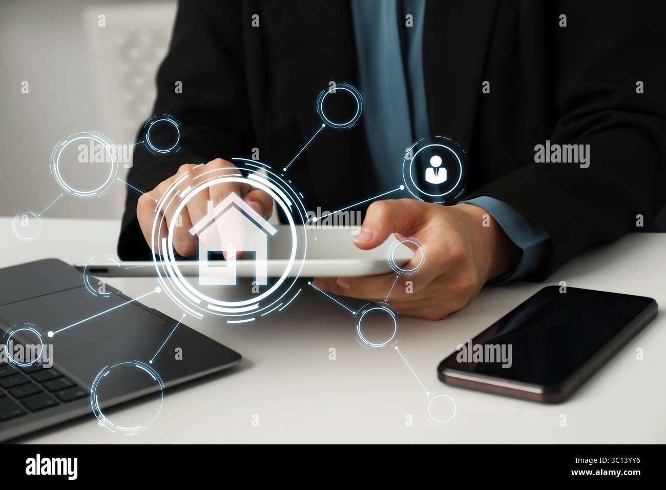 Real estate agent using table computer at table, closeup. Scheme with house icon on virtual screen Stock Photo