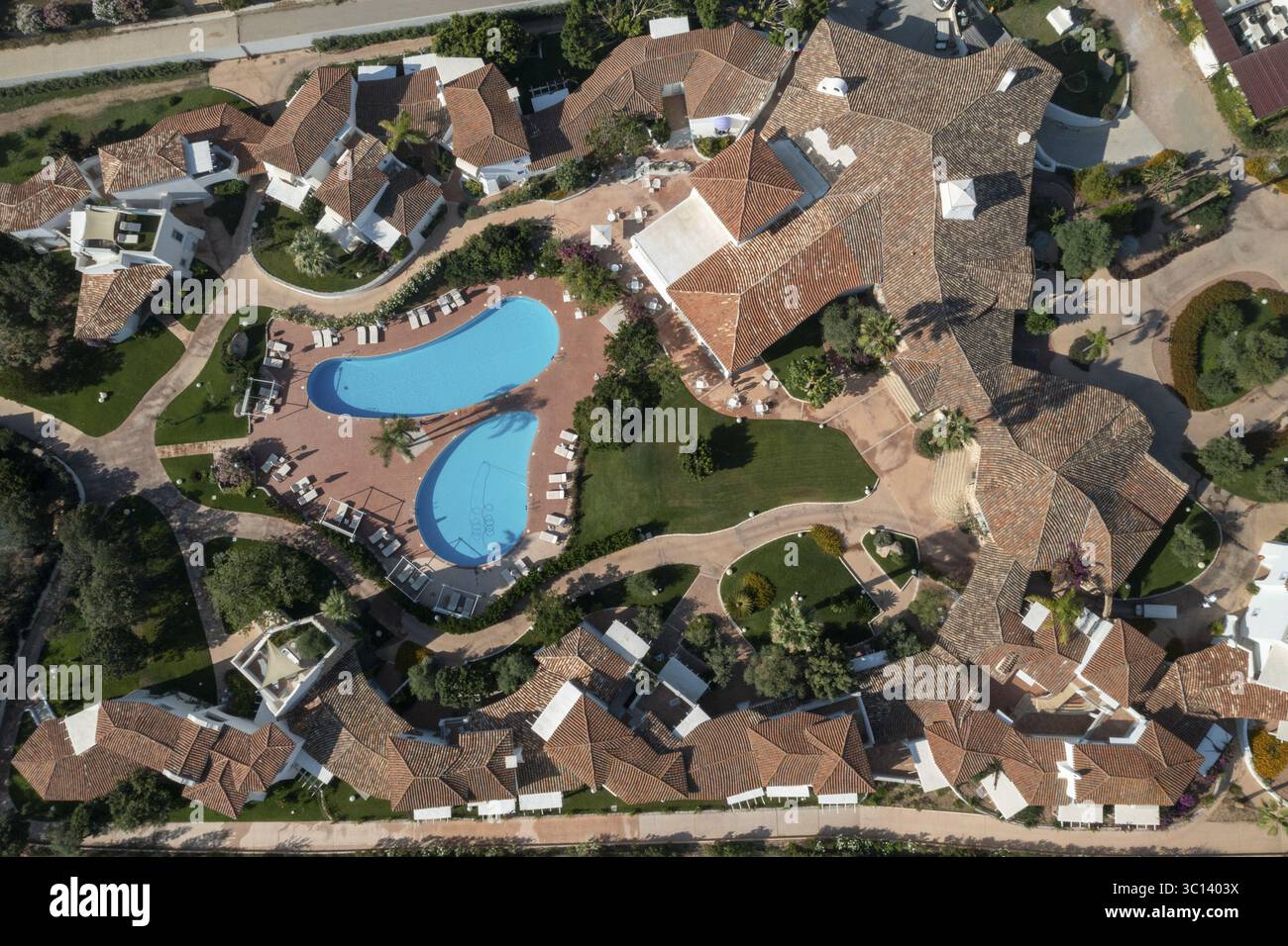 Aerial view of terracotta roofs contrast with the turquoise pools ...