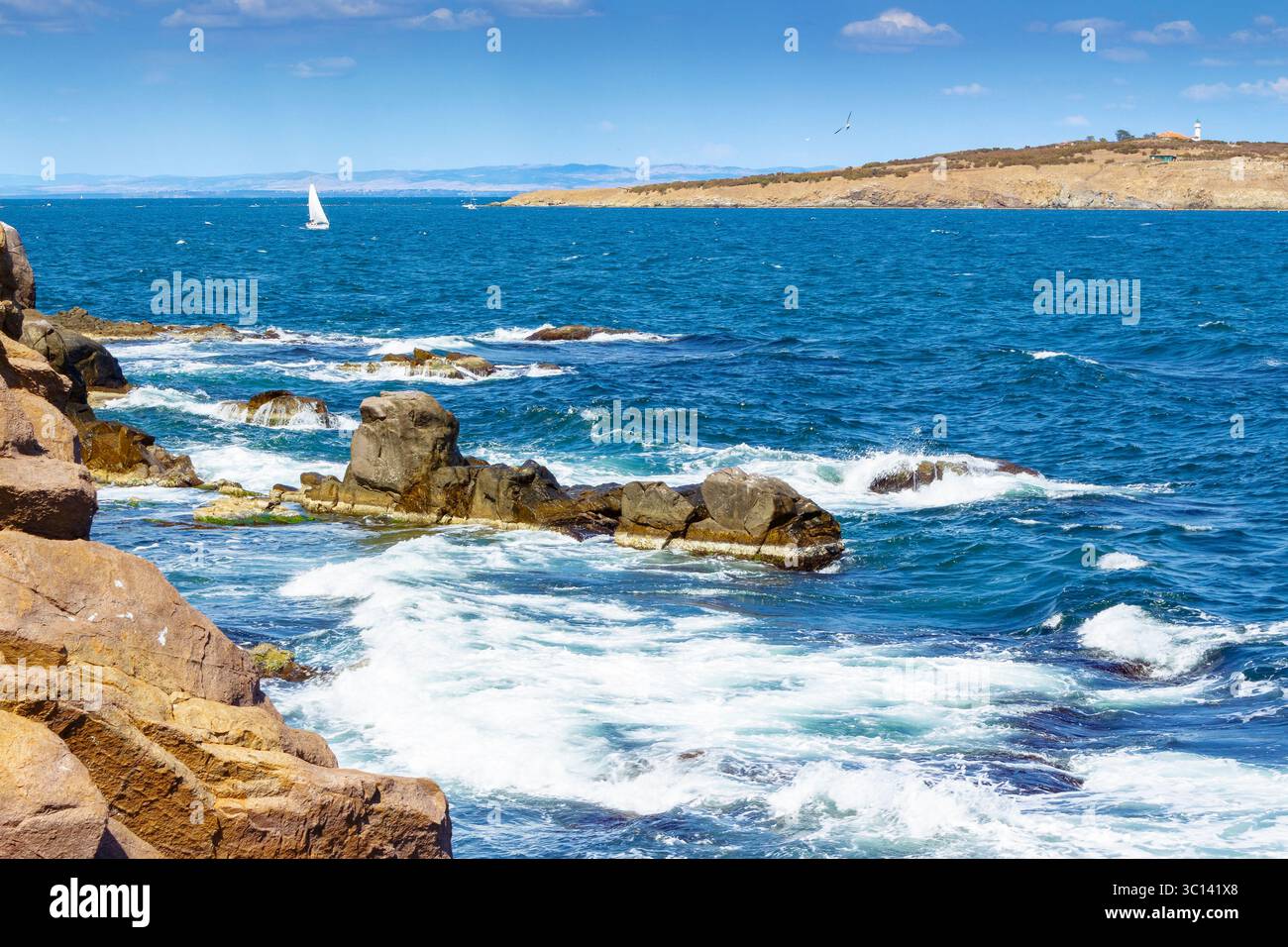 landscape with sea and coast with rock. vacation season with beautiful seascape in summer. travel background with water splash on stone Stock Photo