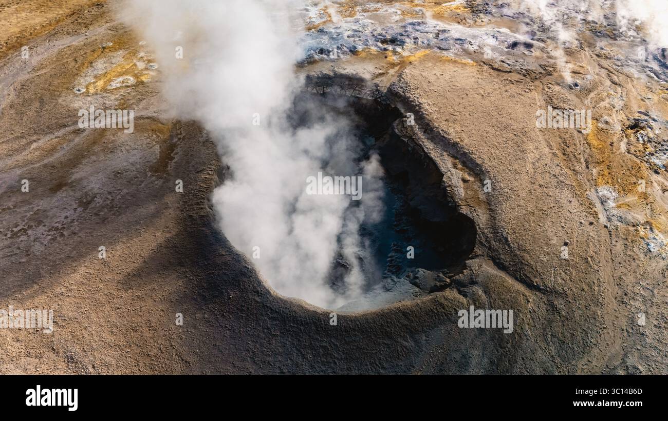 In Hverir Valley, geothermal features create a stunning landscape as steam erupts from the ground, showcasing the raw, untamed beauty of Icelands natural wonders. Stock Photo