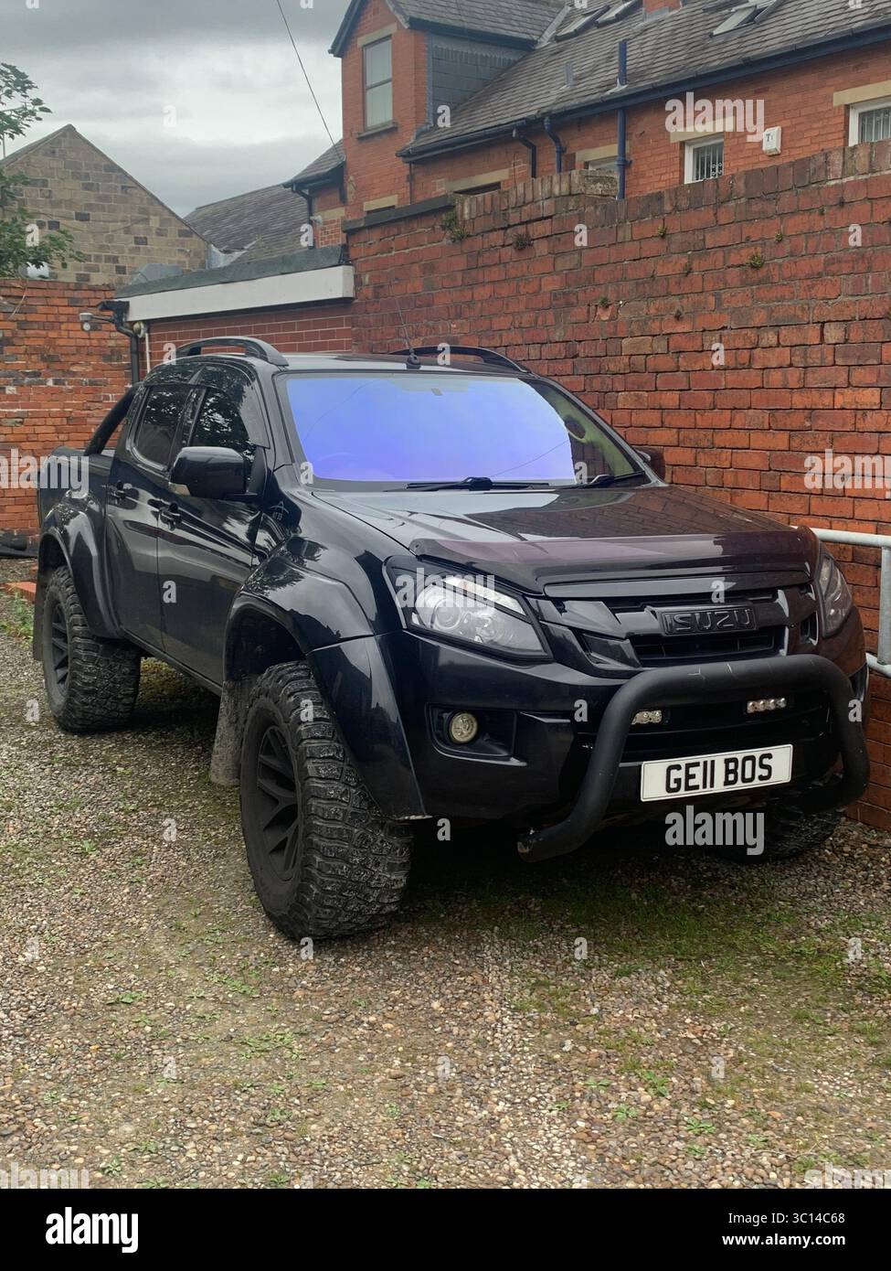 car vehicle Isuzu big large Black shinny UK British machine parked - Smartphone Captured Stock Image