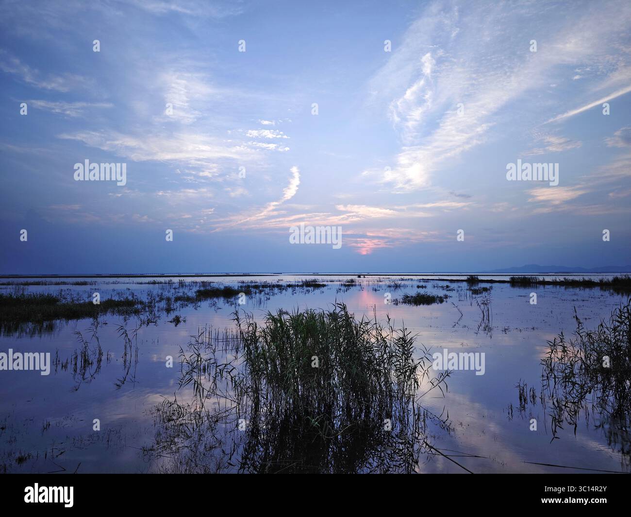 sunset over the lake with deep blue sky Stock Photo