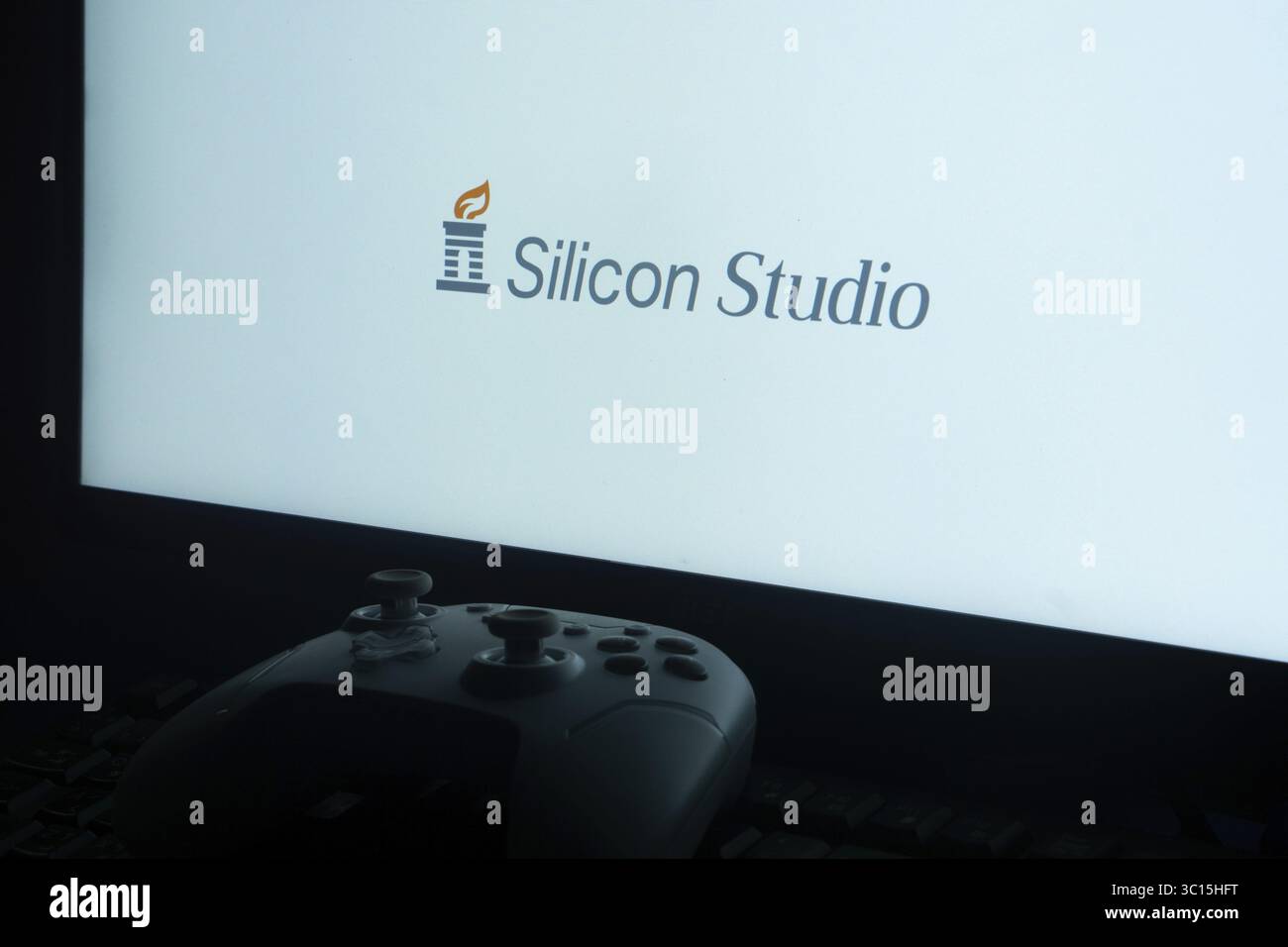 Gaming controller in front of screen showing Silicon Studio logo Stock ...