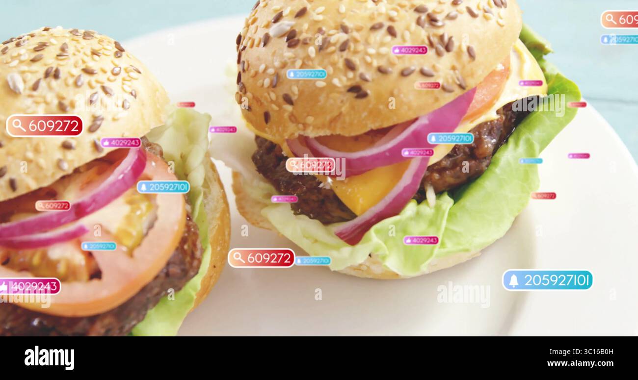 Displaying two cheeseburgers resting on ceramic plate on blue tabletop, with digital numeric tags Stock Photo
