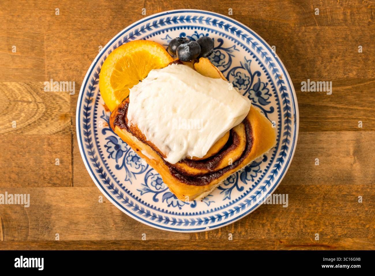Cinnamon bun with frosting Stock Photo