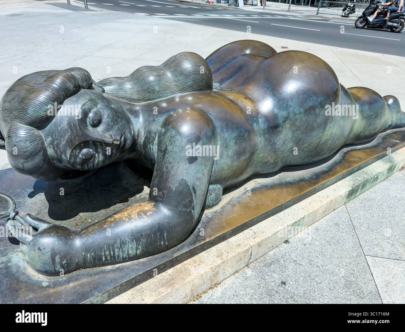 Bronze sculpture “Woman with Mirror” (Mujer con espejo) by Colombian sculptor Fernando Botero, located at Plaza de Colón in Madrid. Spain - Smartphone Captured Stock Image