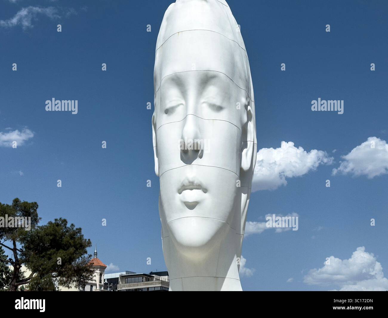 Julia, white marble sculpture by Jaume Plensa in Plaza Colon, Madrid, Spain - Smartphone Captured Stock Image
