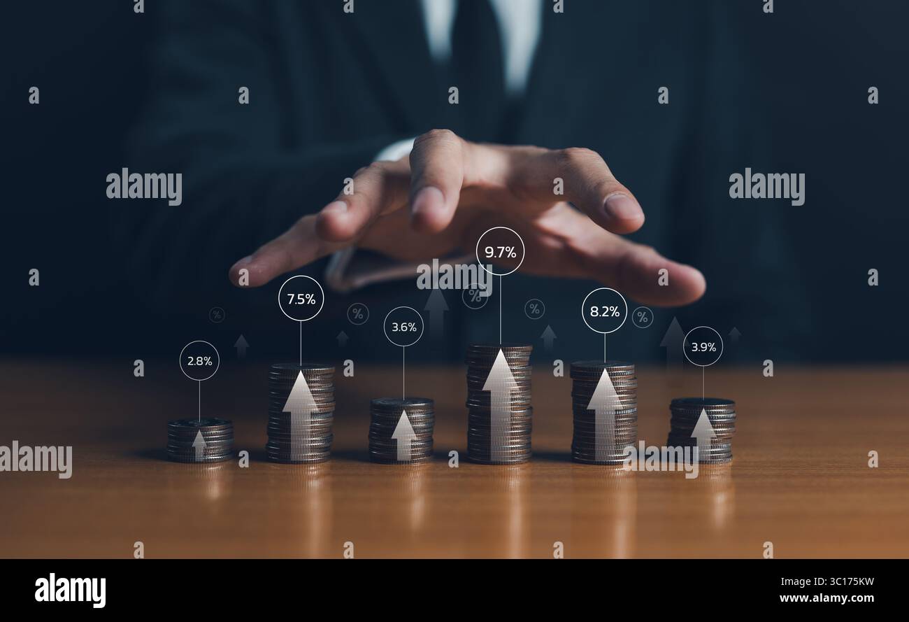 Interest rate increase concept. Rise in cost of borrowing money from financial institutions such as banks. Businessman stacking coins differ high Stock Photo