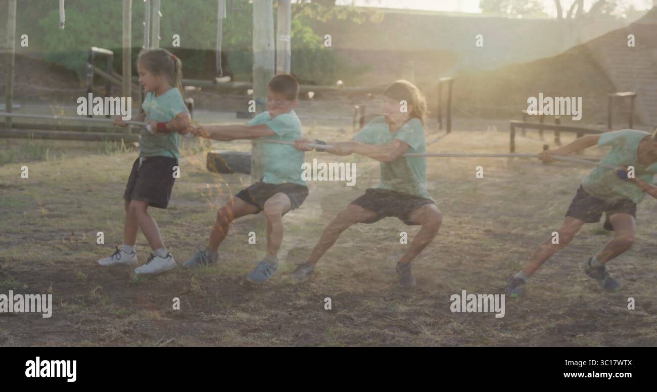 Tuggig Rope Kids tugging rope in sportswear at park playground, with metal bars ...