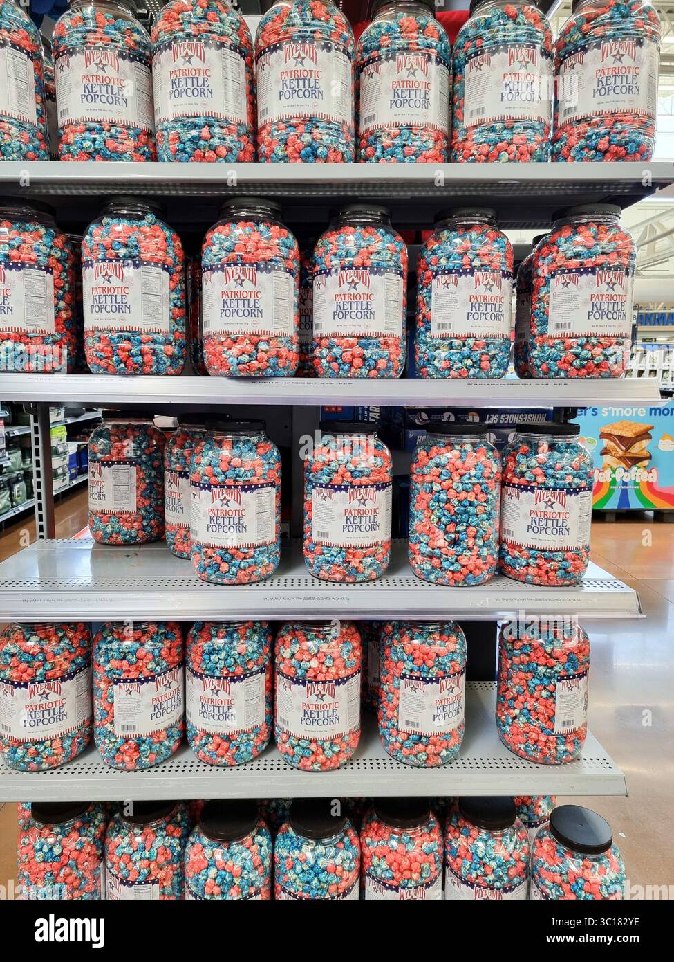 Shop shelves with plastic containers filled with Wye River Patriotic Kettle Popcorn in red white blue colors; American, U.S.A., USA - Smartphone Captured Stock Image