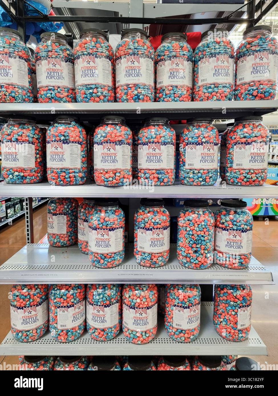 Shop shelves with plastic containers filled with Wye River Patriotic Kettle Popcorn in red white blue colors; American, U.S.A., USA - Smartphone Captured Stock Image