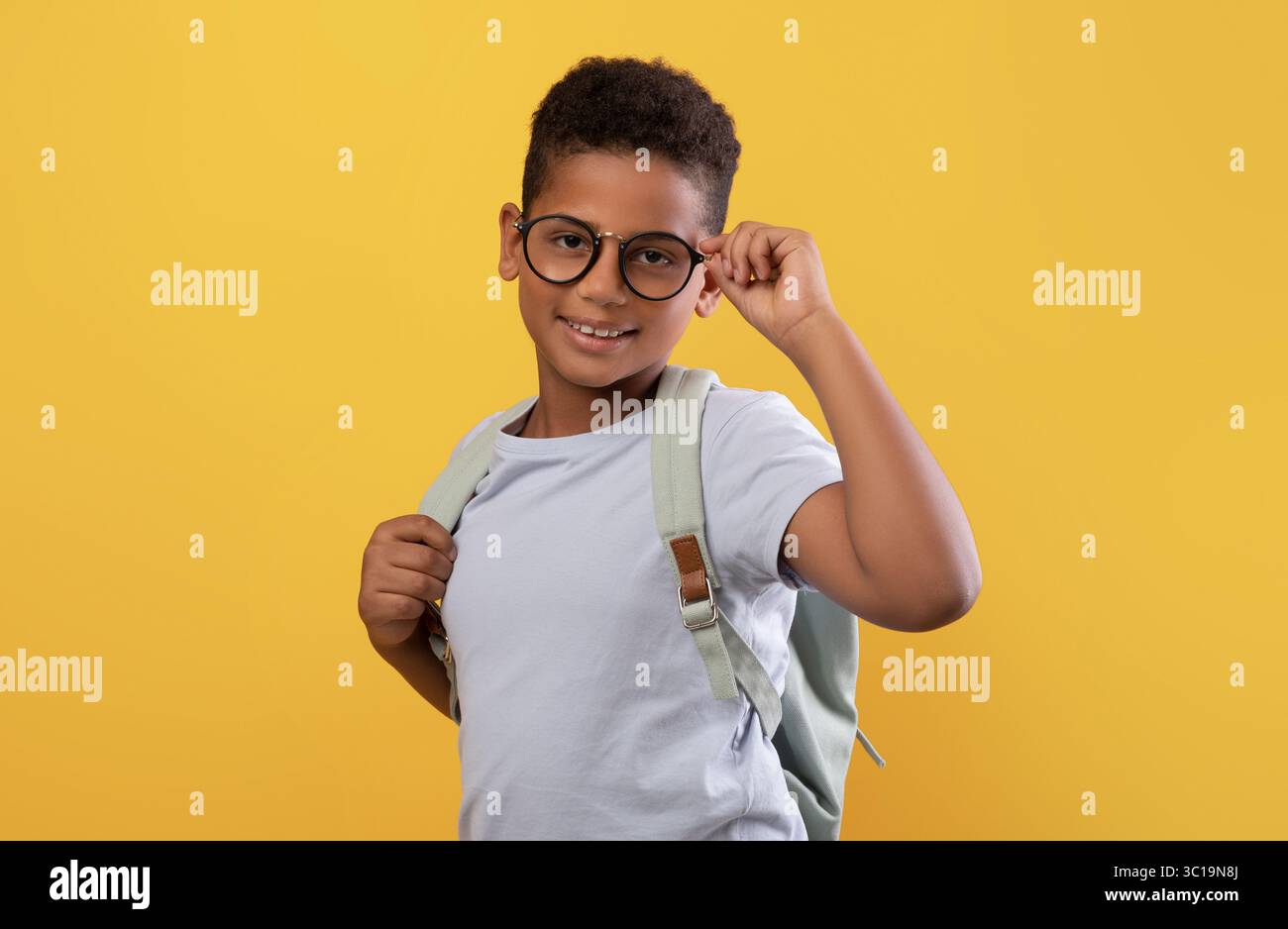 Happy african american school boy with glasses and backpack Stock Photo ...