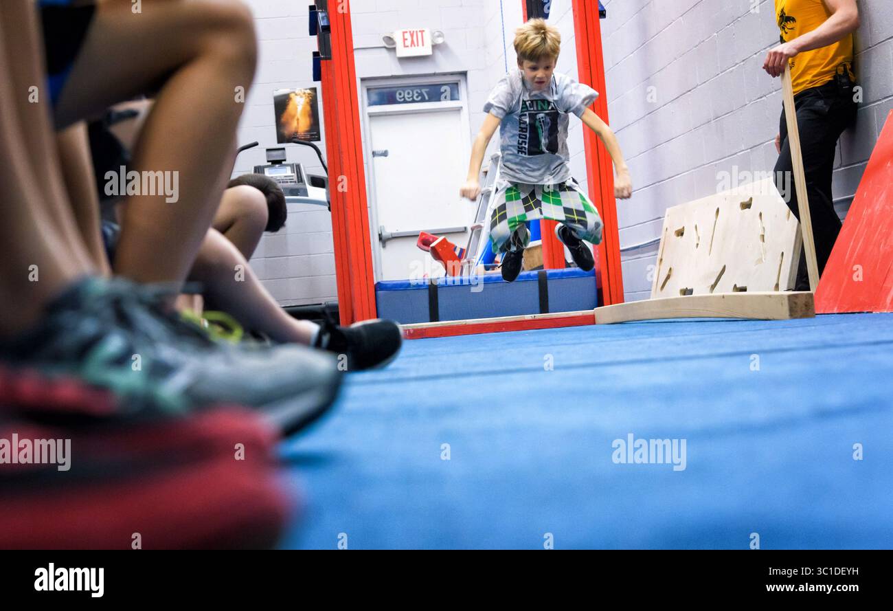 November 21, 2017 - Edina, Minnesota, USA - Alex Howie tested at the broad jump. Tuesday, November 21, 2017 ..If you want your kid to drop the video game controller and get off the couch, you can take your pick of gyms and clubs and teams in the Twin Cities in sports ranging from fencing to figure skating to rowing...Add being a ninja warrior...In the last two or three years, at least six gyms have sprung up in the metro area offering to train people to be ninja warriors just like on the obstacle course contest NBC television show, ''American Ninja Warriors.'' At least two more gyms are being Stock Photo