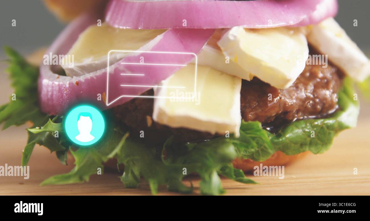 Displaying gourmet burger with cheese and onion rings on wooden board ...