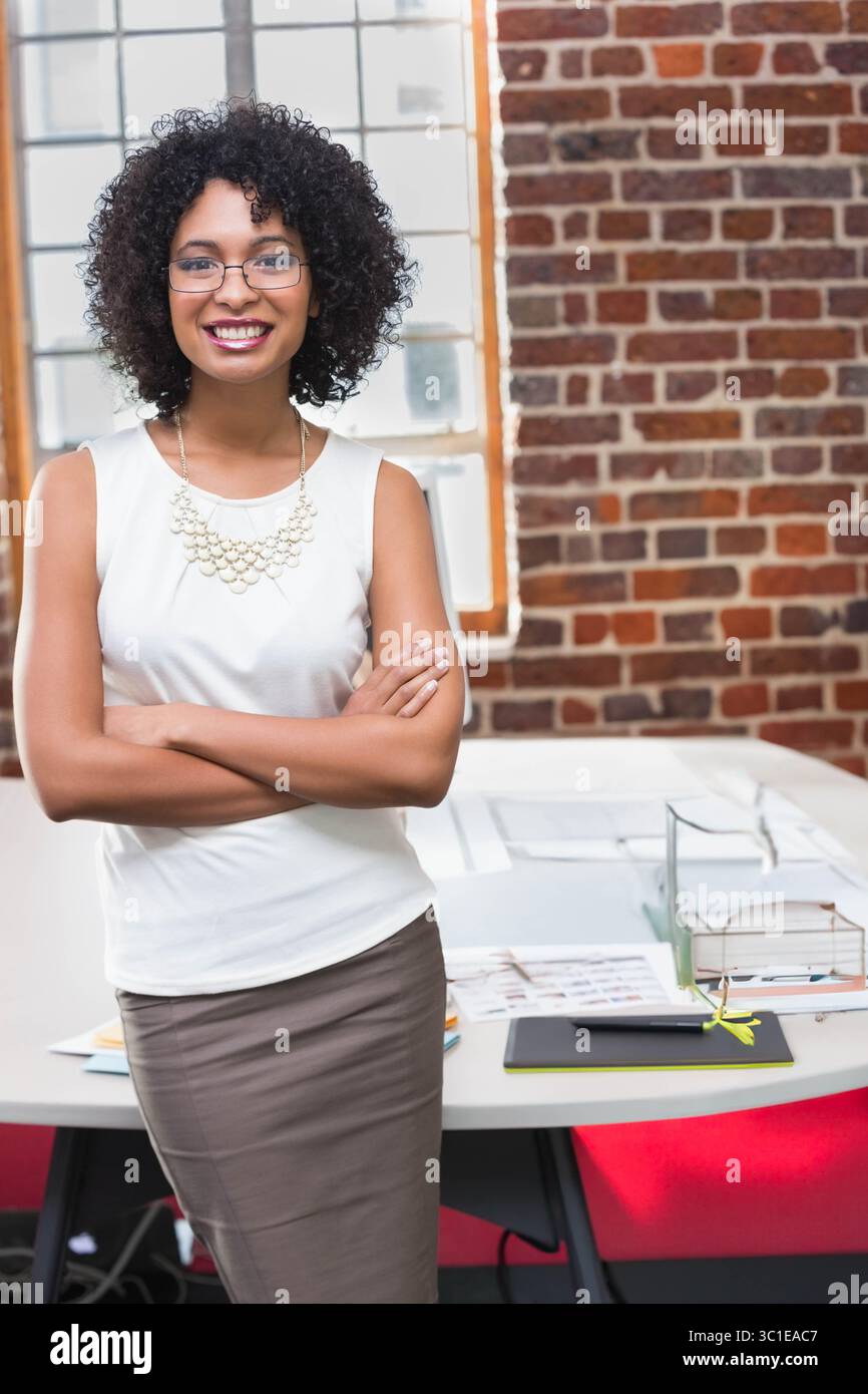 African American woman wearing suit standing behind desk in office loft ...