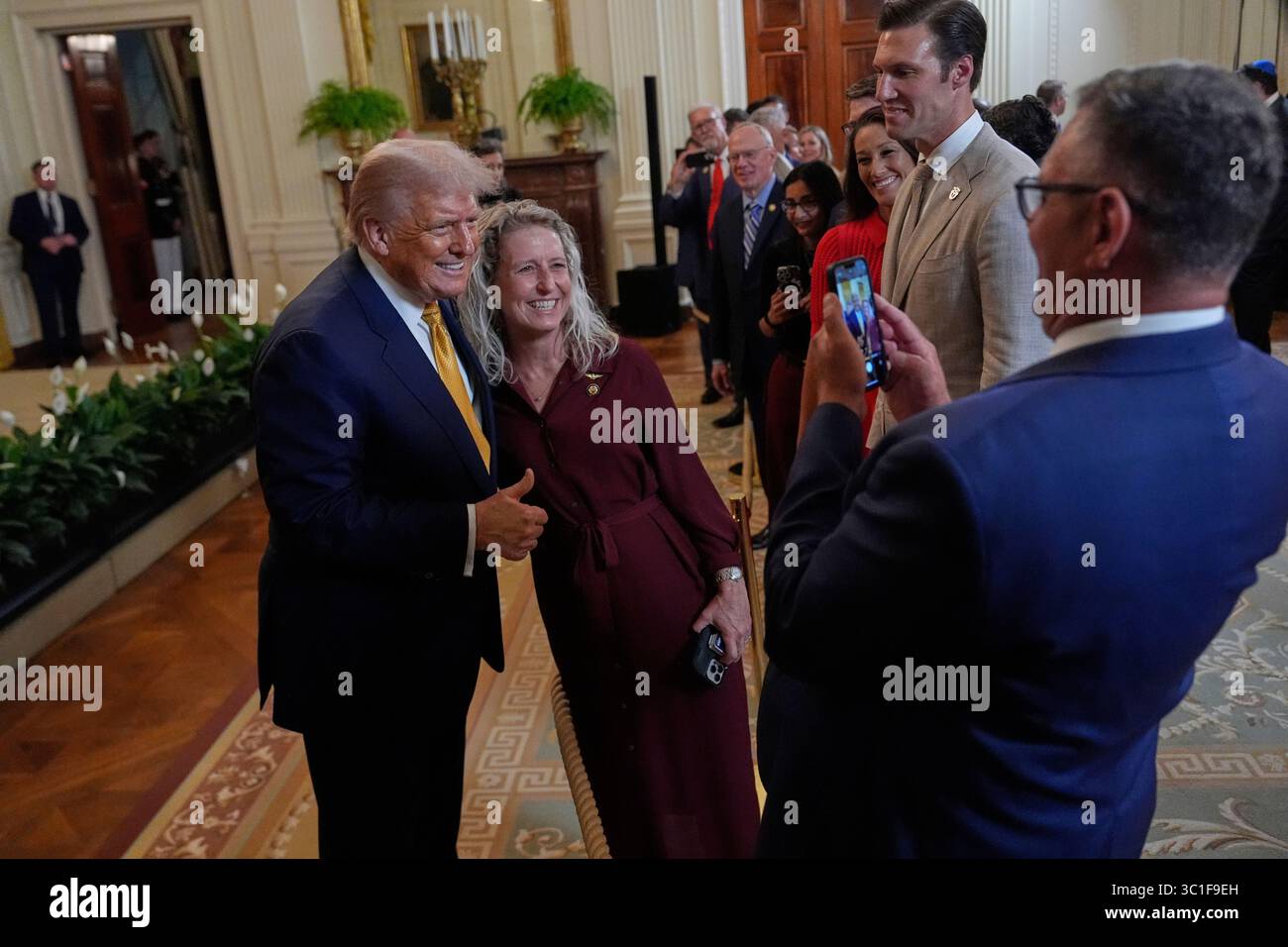 President Donald Trump greets people during a reception for Republican ...