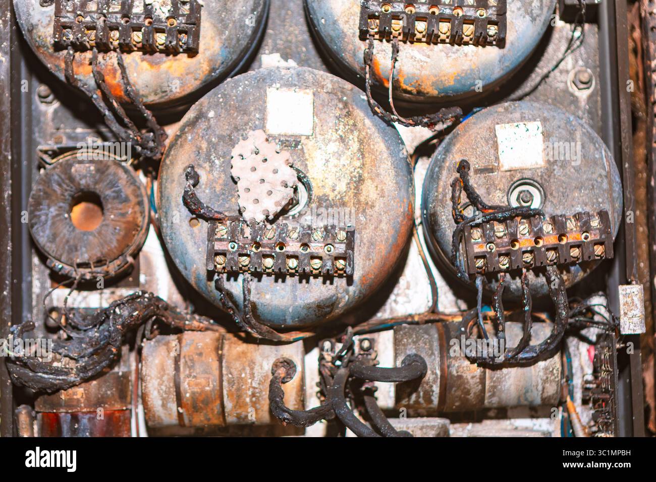Electrical panel damaged after a fire with charred wires and melted ...