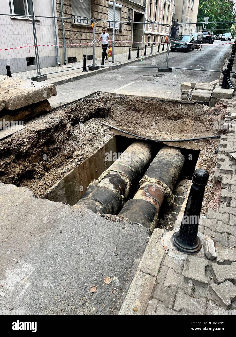 Ongoing pipeline replacement work on a city street in Sofia, Bulgaria, urban infrastructure maintenance and underground utility upgrade Europe, EU - Smartphone Captured Stock Image