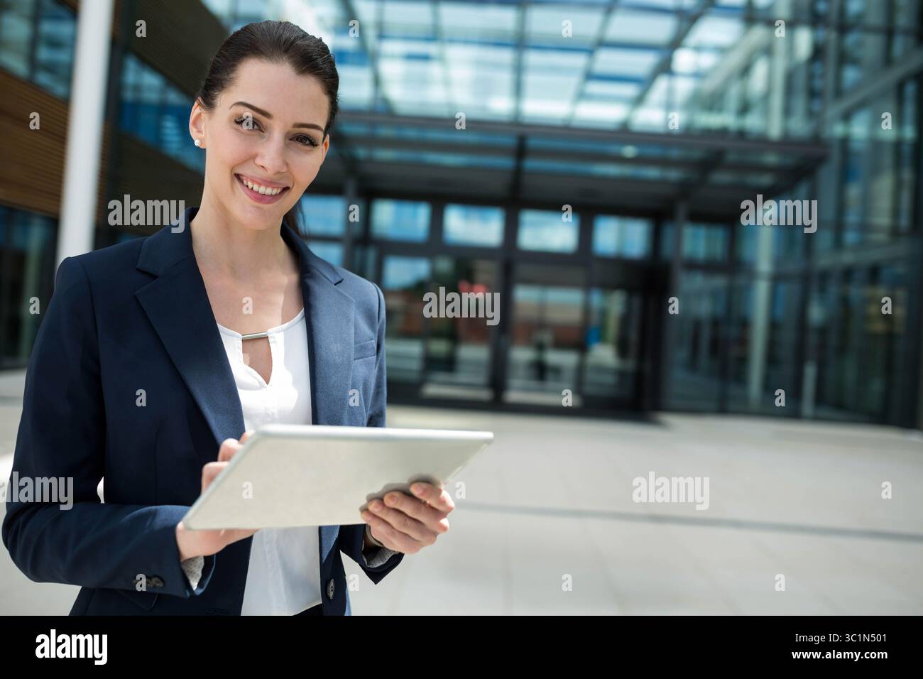Tablet computer is displaying dashboard outside office building under ...