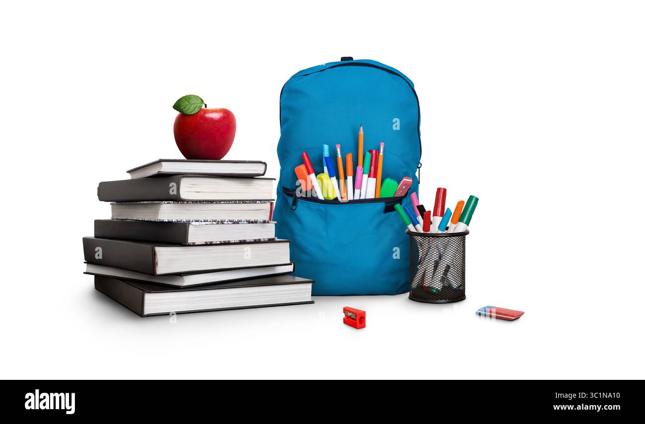 A back to school scene of a pile of three study books to learn from, a red apple, blue school bag, pens and pencils isolated against white background Stock Photo