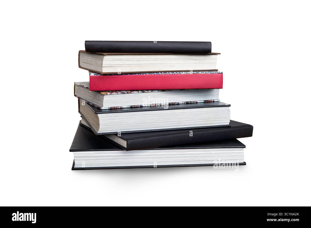 A front side on view of a pile of seven study books, textbooks, on a table isolated against a white background Stock Photo