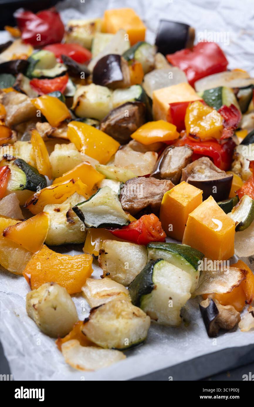 Roasted vegetables on a baking tray isolated on white background Stock Photo