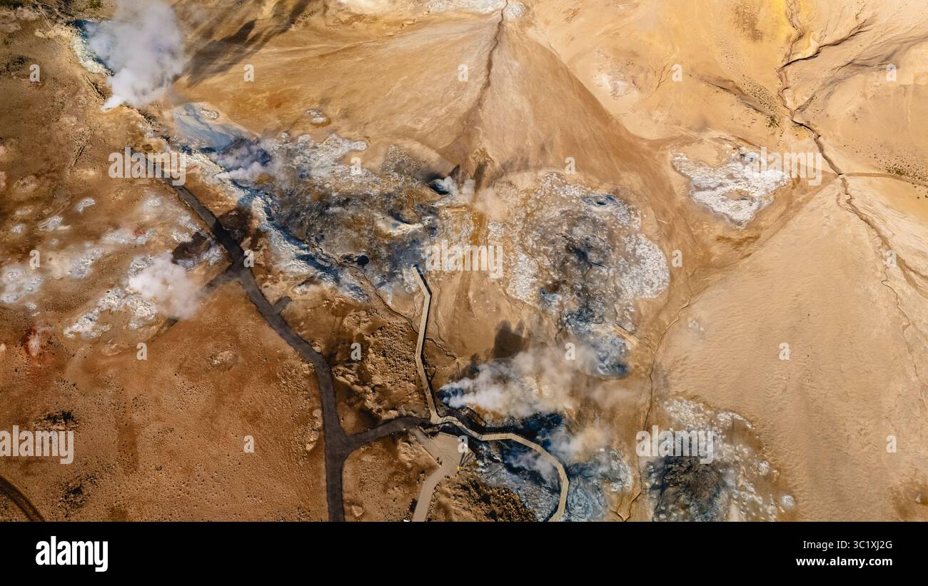 Explore the stunning Hverir geothermal features of Iceland, where steam rises from the earth and vibrant colors create a captivating landscape. Stock Photo