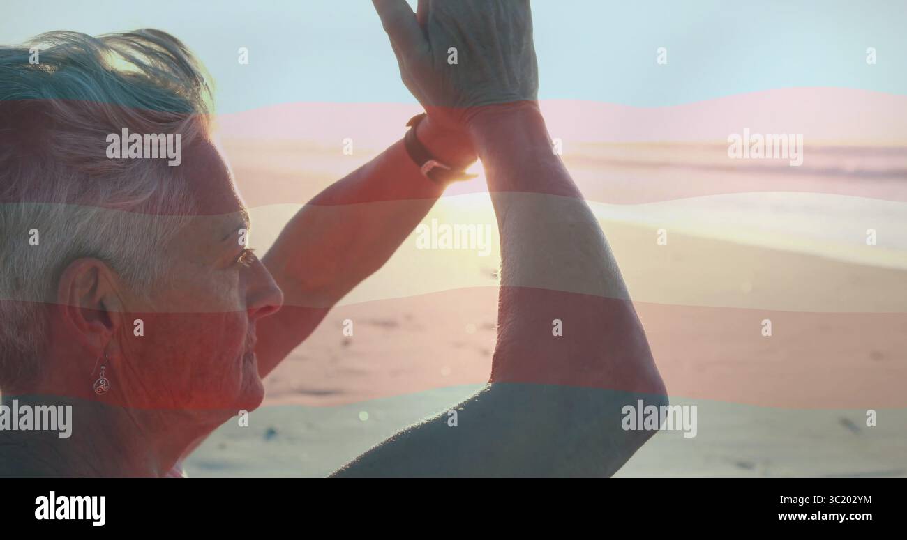Doing yoga prayer pose woman at beach sunset in sleeveless top with wristwatch, earring, copy space Stock Photo